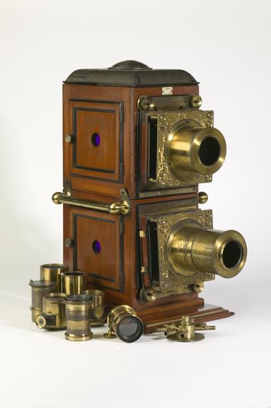 Biunial lantern slide projector with lenses and attachements