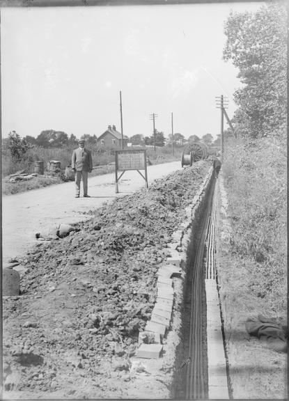 Works photographic negative of cables laid by rural road