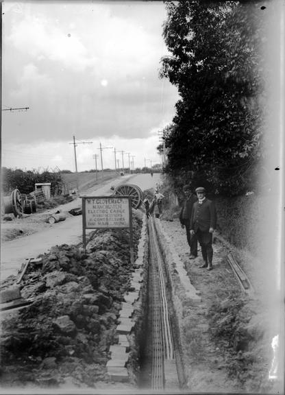 Works photographic negative of cables laid by rural road