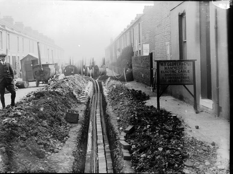 Works photographic negative of cable laying in terraced street