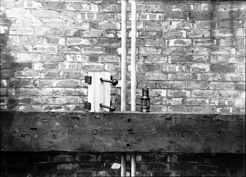 Works photographic negative of a vertical cable in cleat on pit