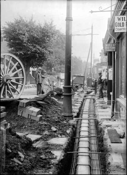 Works photographic negative of cables, in suburban street