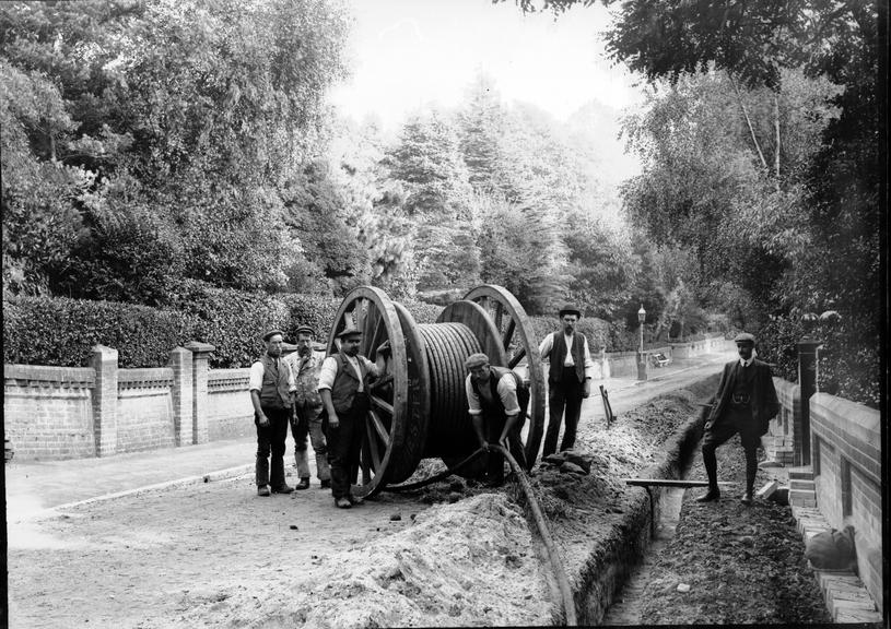 Works photographic negative of men laying cable, Bournemouth