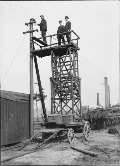 Works photographic negative of men working on overhead wires