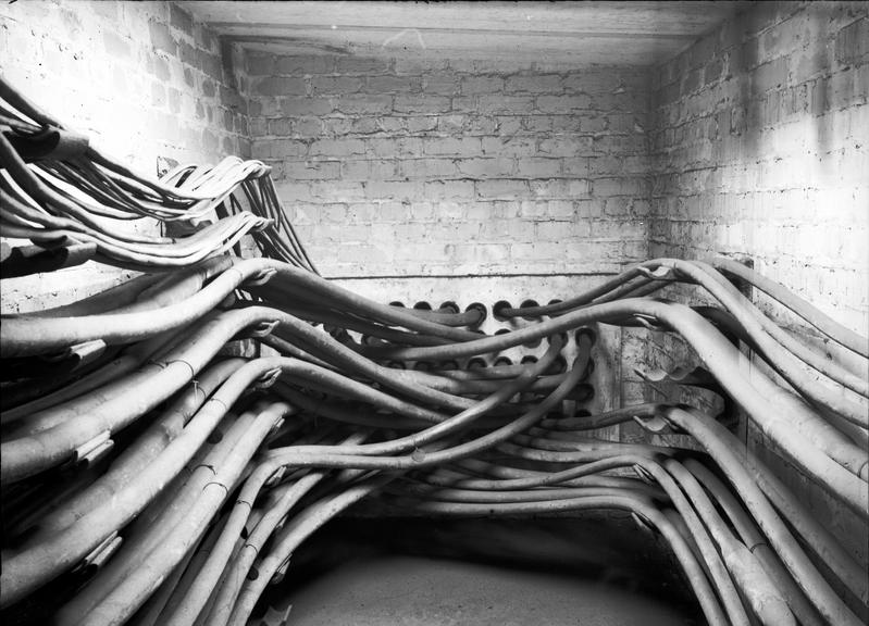 Works photographic negative of cables on wall brackets