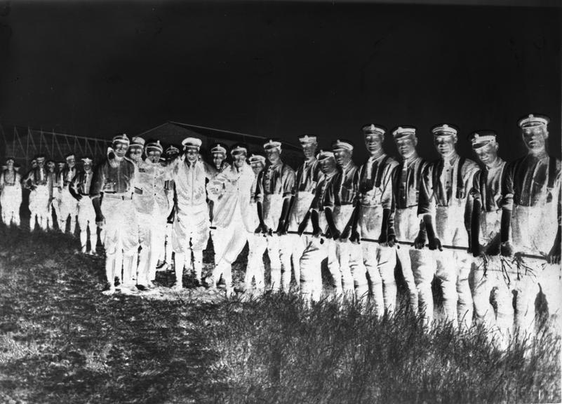 Works photographic negative of men holding cable