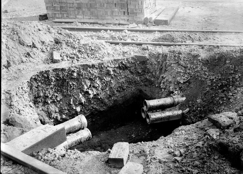 Works photographic negative of pit in roadway