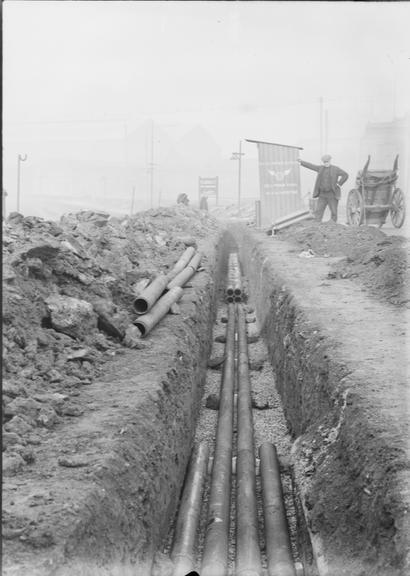 Works photographic negative of pipes in trench