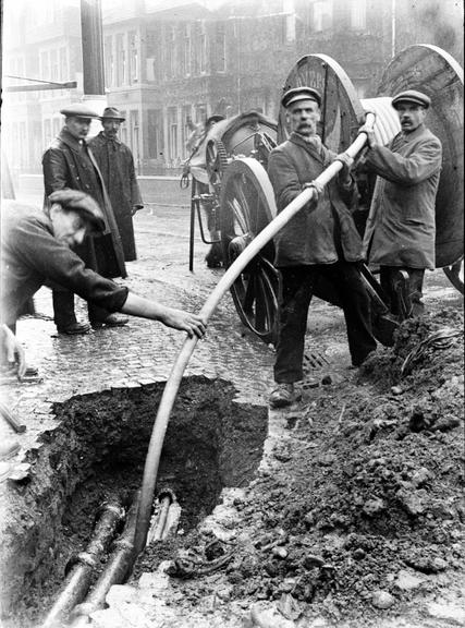 Works photographic negative of men laying cable, Sheffield