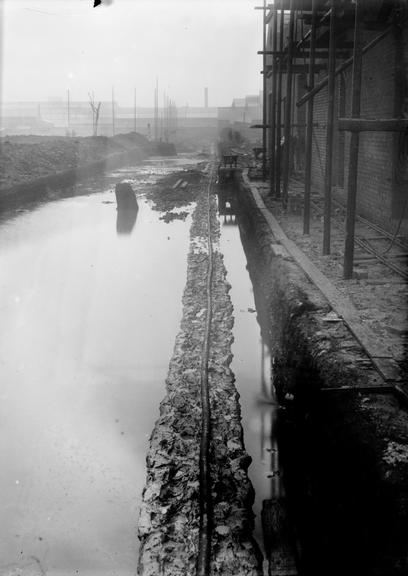 Works photographic negative of cable in flooded area