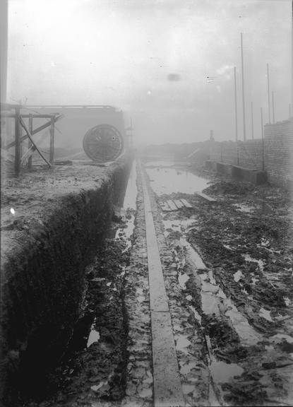 Works photographic negative of cable in flooded area