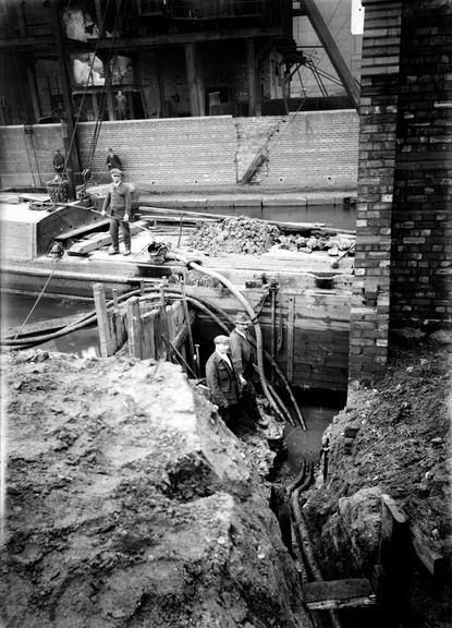 Works photographic negative of cable laying near canal