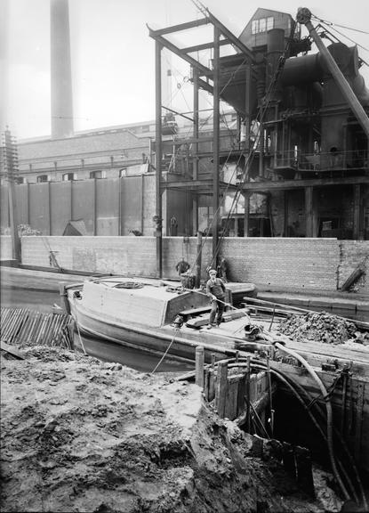 Works photographic negative of cable laying near canal