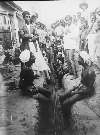 Works photographic negative of local men in trench, Madras