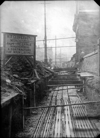 Works photographic negative of cables in troughing, Manchester