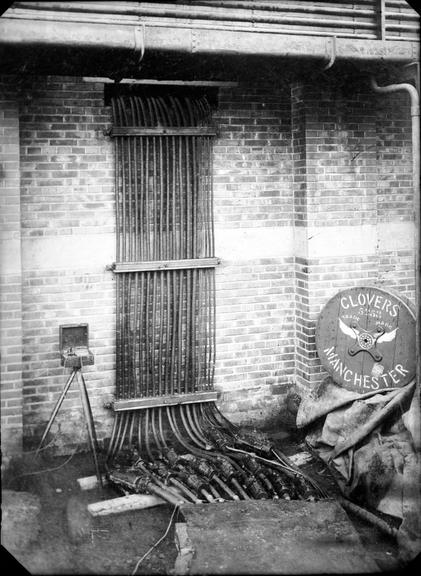 Works photographic negative of cables emerging from building