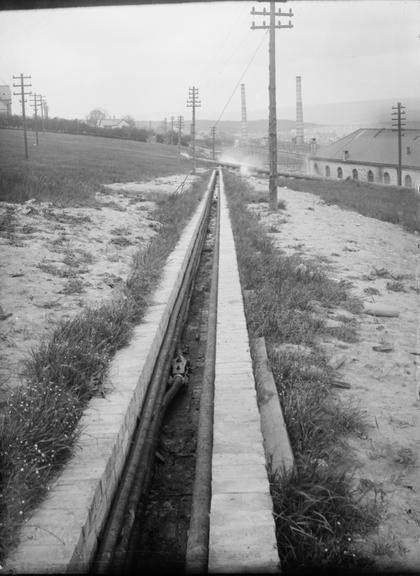 Works photographic negative of cables supported on brick trench