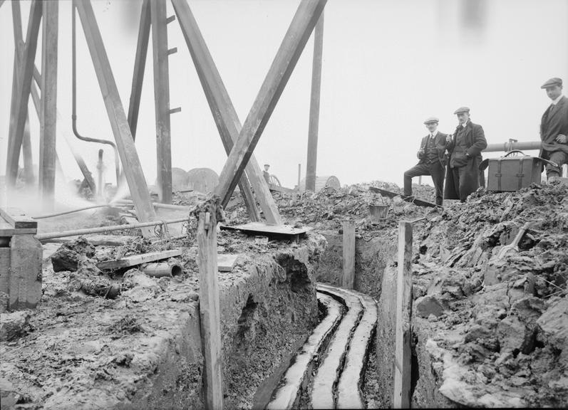 Works photographic negative of cables in filled troughing