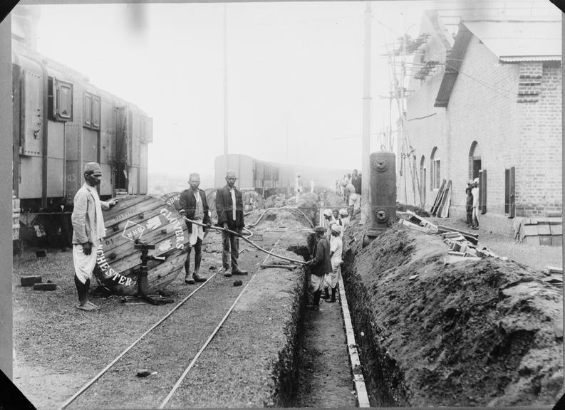 Works photographic negative of local men laying cable