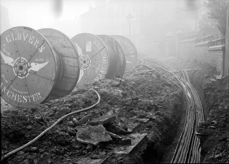 Works photographic negative of cables being laid in troughing