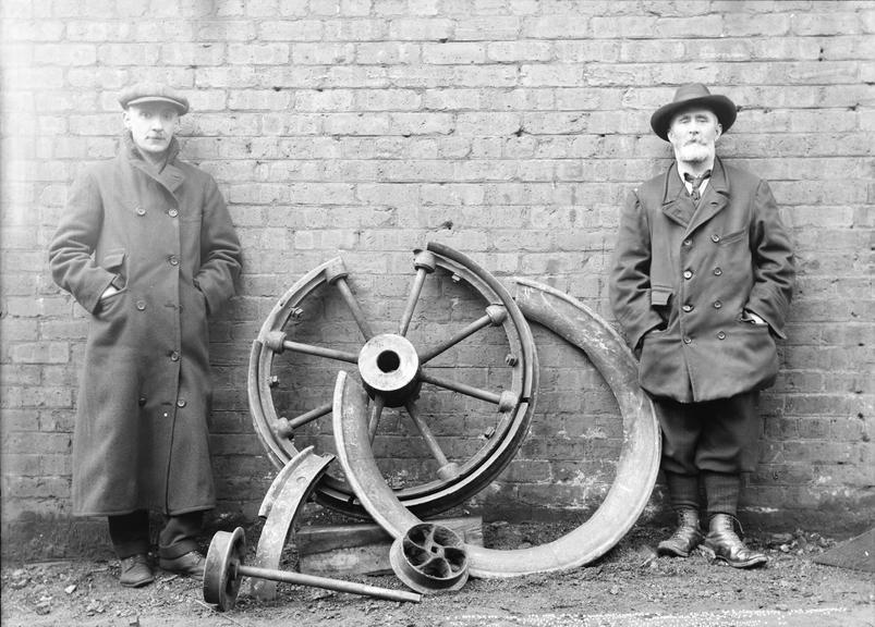 Works photographic negative of men by broken wheels