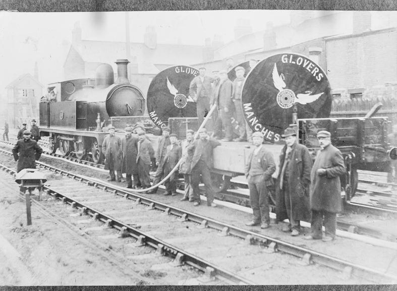 Works photographic negative of men laying out cable