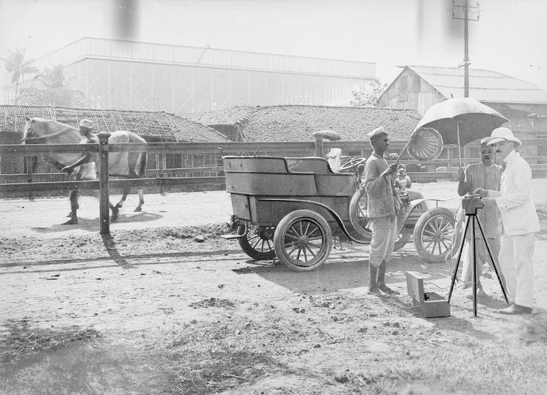 Works photographic negative of man working with instrument on