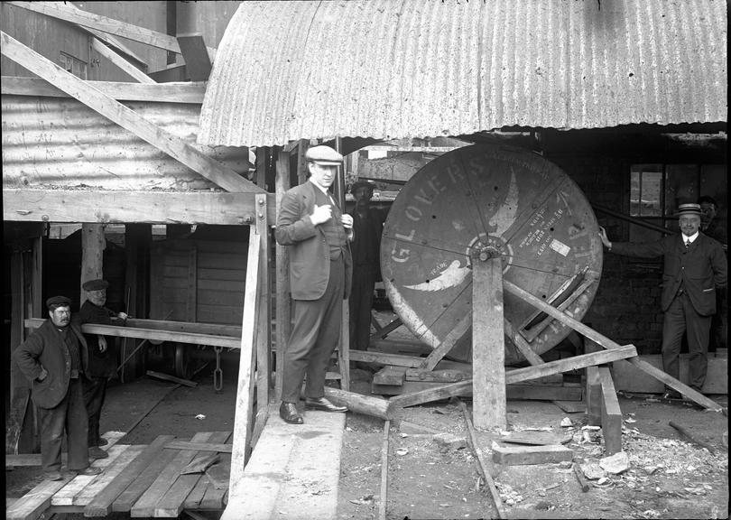 Works photographic negative of man by cable drum