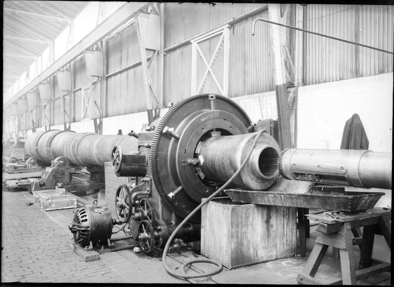 Works photographic negative of gun barrel on borer