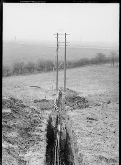 Works photographic negative of cables in trench