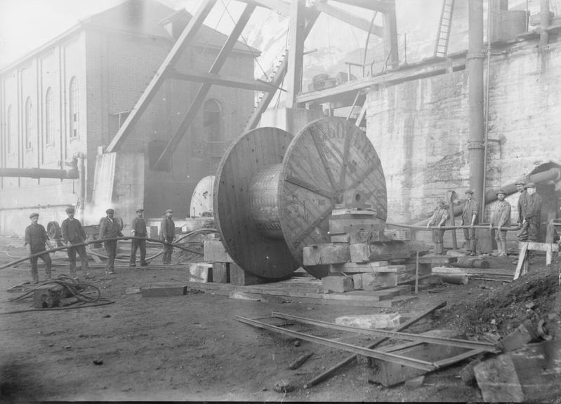 Works photographic negative of men holding cable at pit head