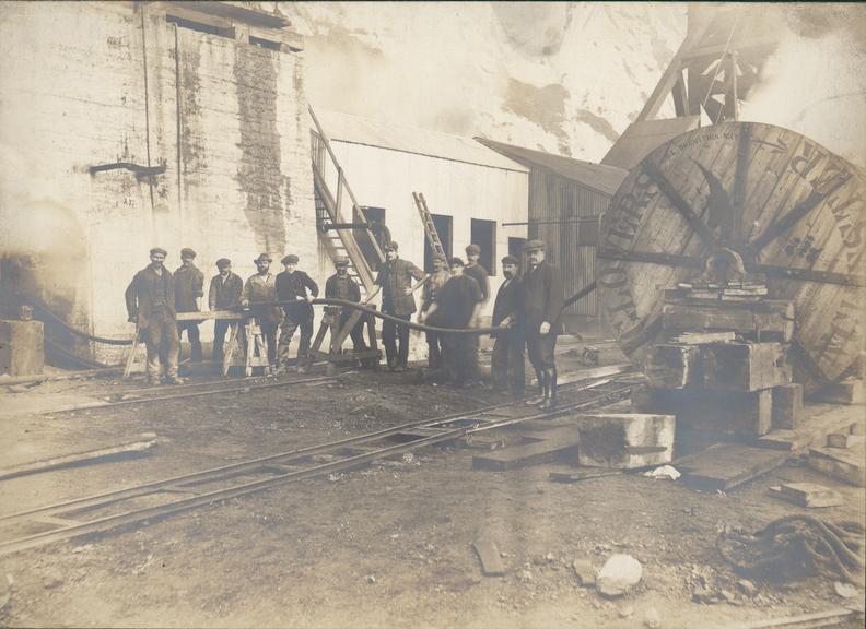 Works photographic negative of men holding cable at pit head