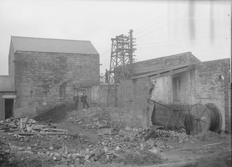 Works photographic negative of men erecting gantry