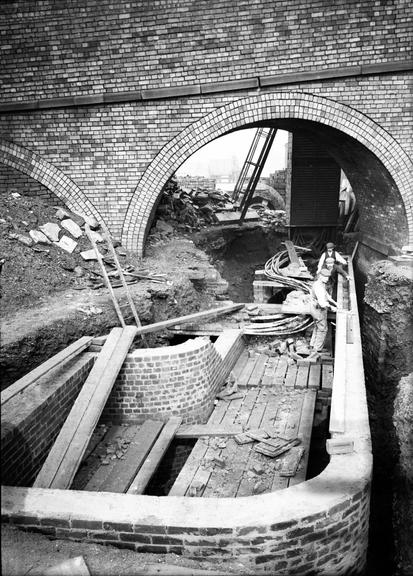 Works photographic negative of men working on cable tunnel