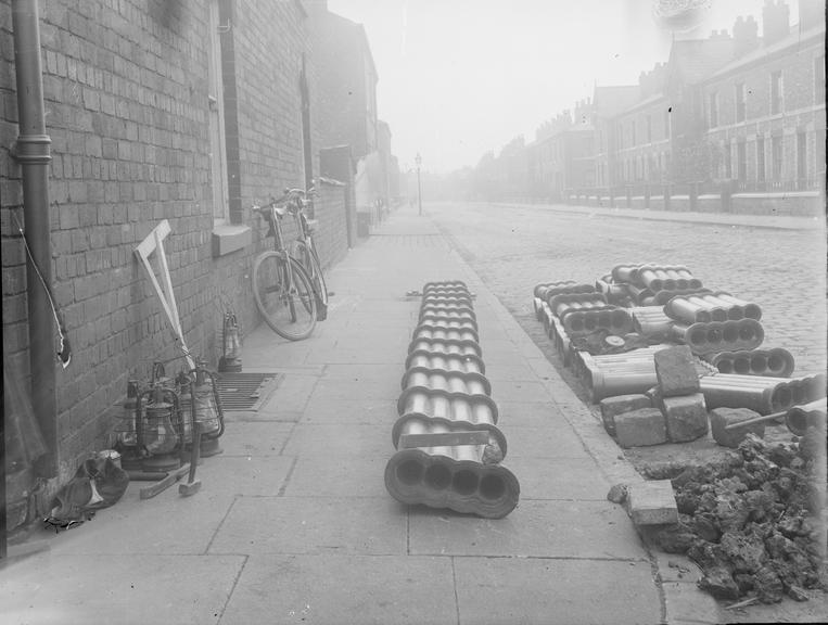 Works photographic negative of conduit on pavement