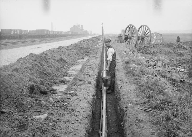 Works photographic negative of cable in troughing