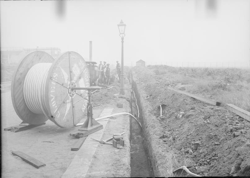 Works photographic negative of cable in troughing