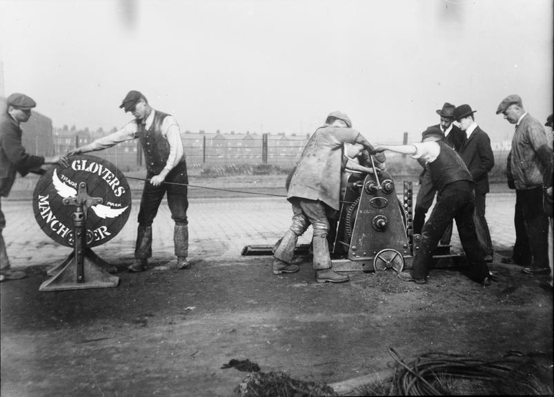 Works photographic negative of men using crab winch