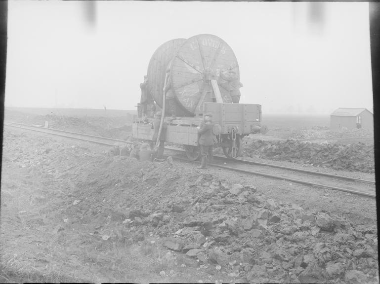 Works photographic negative of cable drum on railway wagon