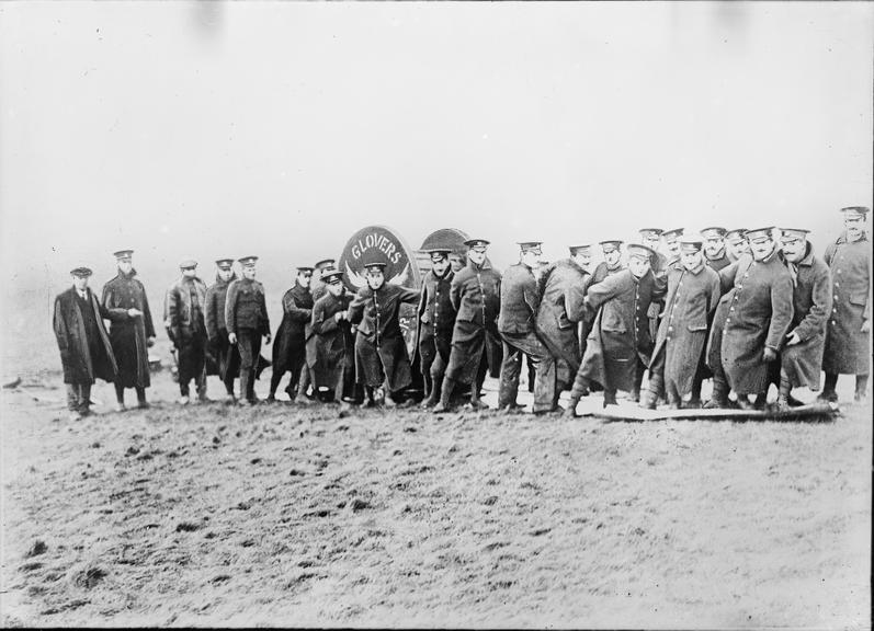 Works photographic negative of soldiers hauling cable drum