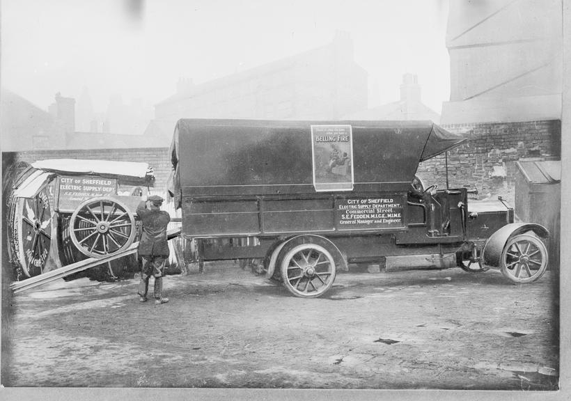 Works photographic negative of men loading cart into lorry