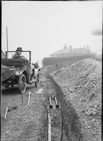 Works photographic negative of conduit sections in trench