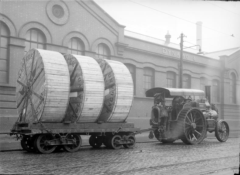 Works photographic negative of cable drums being pulled by