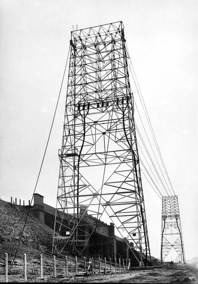 Works photographic negative of gantries beside railway bridge