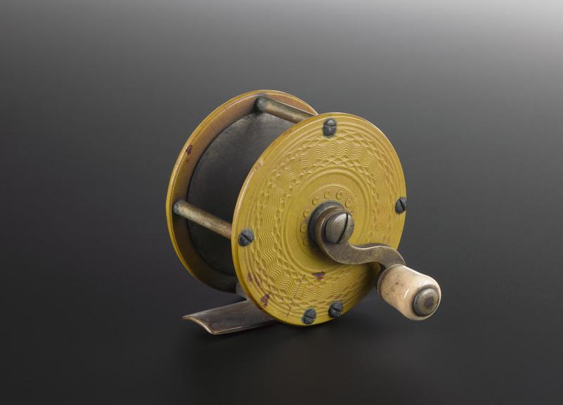 Fishing rod spool of yellow Parkesine with brass fittings