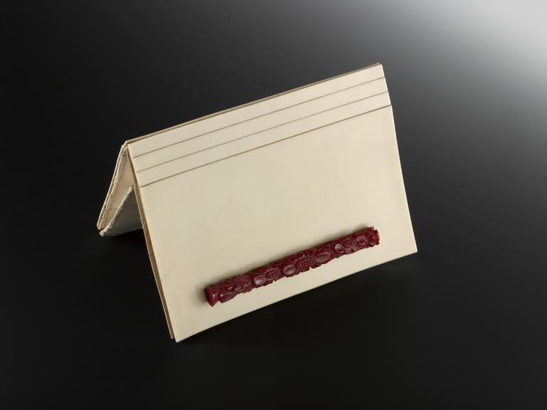 Hand bag of cream urea formaldehyde with red moulded handle