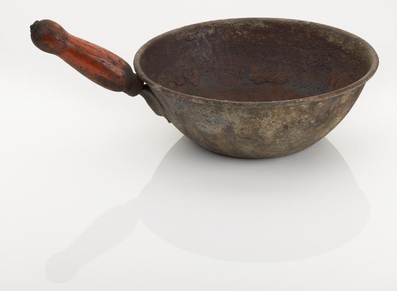 Water bail, metal/wooden handle, used in a public bathhouse.