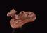 Red earthenware foot-scraper in the form of a recumbent camel