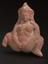 Unglazed moulded terracotta fertility figure with traces of engobe