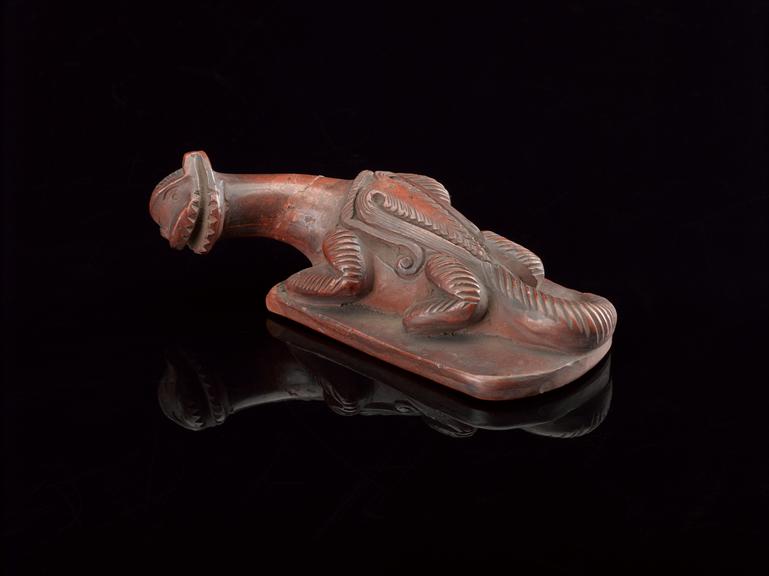 Earthenware foot scraper in the form of a reptile